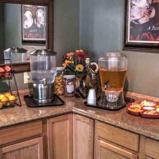 A cozy buffet corner with beverages and snacks on display.