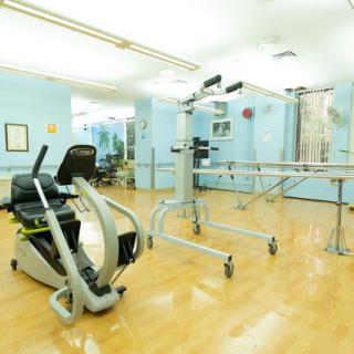 A spacious rehabilitation gym featuring exercise equipment for physical therapy.