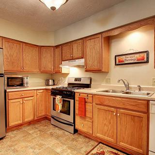 A cozy kitchen with wooden cabinets and stainless steel appliances.