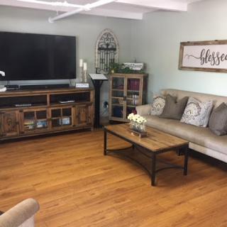 A cozy living room featuring comfortable seating and a modern entertainment setup.
