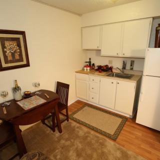 A cozy kitchen and dining area with a small table set for two.
