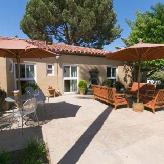 A sunny patio with comfortable outdoor seating and umbrellas.