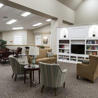 A cozy living room with comfortable seating and a built-in bookshelf, perfect for relaxation.