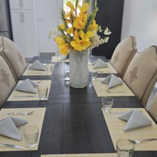 A beautifully arranged dining table with elegant dcor and fresh flowers.