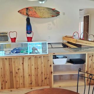 A cozy interior featuring a wooden counter and surfboard decor.