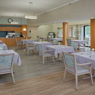 A spacious dining room with neatly arranged tables and chairs.