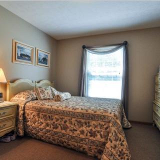 A cozy bedroom with patterned bedding and a warm atmosphere.