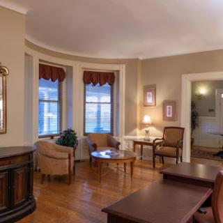 A cozy living room featuring elegant furniture and beautiful window views.