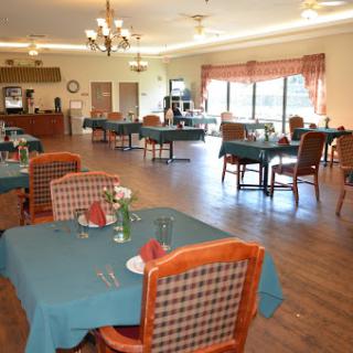 A spacious and inviting dining area with neatly set tables, ready for guests.
