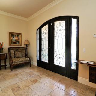 A beautifully decorated entryway with elegant doors and tasteful furnishings.