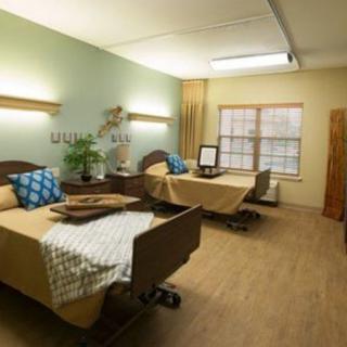A hospital room featuring two neatly made beds with a calm and welcoming atmosphere.