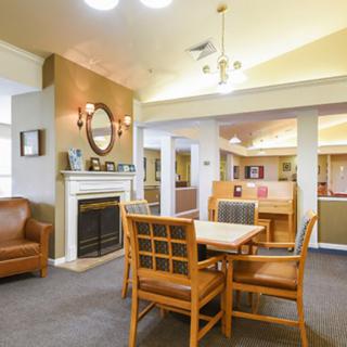 A cozy living area featuring a fireplace, dining table, and comfortable seating.