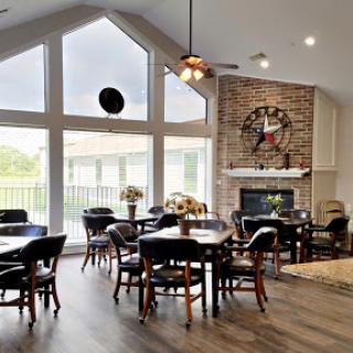 A spacious and inviting lounge area with large windows and a cozy fireplace, perfect for gatherings.