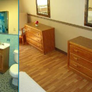 A cozy room featuring wooden furniture with an adjoining bathroom.