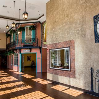 A beautifully designed interior with colorful walls, a traditional clock, and decorative hanging lights.