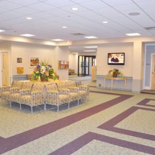 A spacious waiting area with comfortable seating and a television.