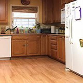 A cozy kitchen with wooden cabinets and modern appliances.