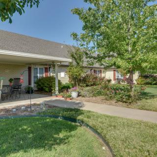 A residential house with a landscaped yard and patio.
