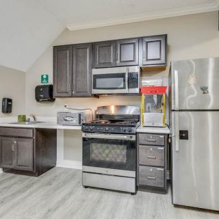 A modern kitchen with stainless steel appliances and dark wood cabinets.