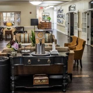 A cozy lobby interior with elegant furniture and decorative elements.