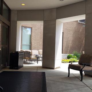 A serene lobby area leading to a cozy courtyard with seating.