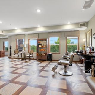 A contemporary barber shop featuring stylish chairs and an inviting atmosphere.