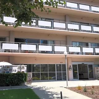 Exterior view of a modern hotel building with multiple balconies.