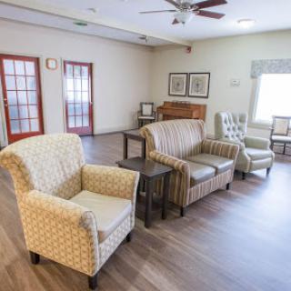 A cozy living room space with comfortable seating and warm lighting.