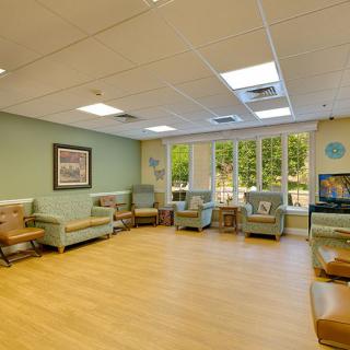 A spacious waiting room with comfortable chairs and large windows.