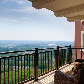A peaceful balcony overlooking a scenic landscape.