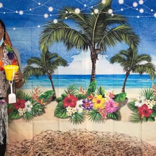 Enjoying a tropical paradise backdrop with vibrant flowers and palm trees.