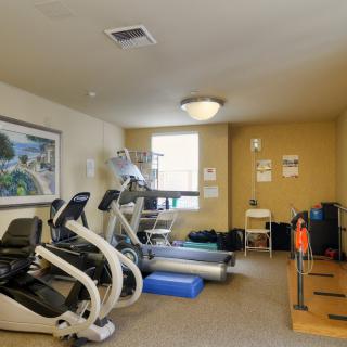 Small fitness room with treadmills and exercise bikes.