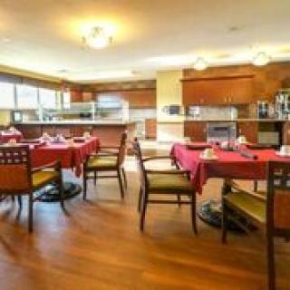 A cozy dining area with red tablecloths and wooden furnishings.