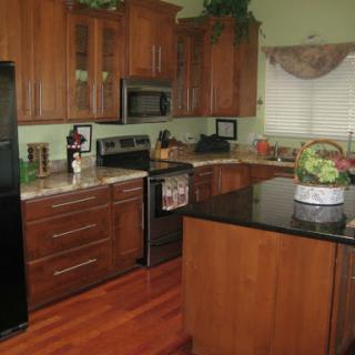 A cozy and modern kitchen with wooden cabinets and sleek appliances.