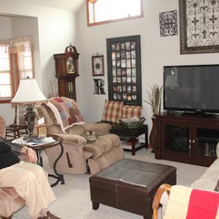 A cozy living room setup featuring comfortable seating and a television.