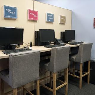 A row of computer workstations set up in an office environment.