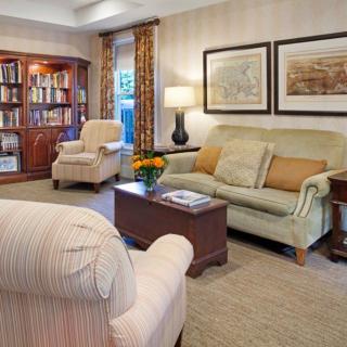 A cozy living room with comfortable seating and a well-stocked bookshelf.