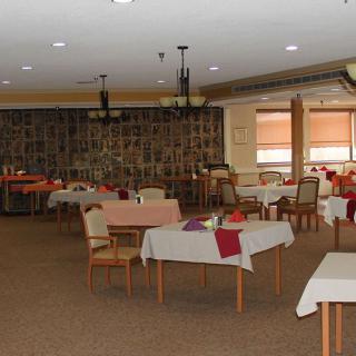 An empty restaurant dining area with neatly arranged tables and chairs.