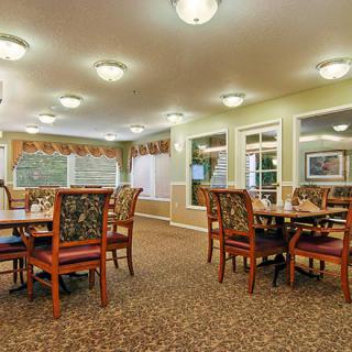 A spacious, well-lit dining area with neatly arranged tables and chairs.