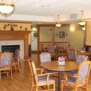 A cozy dining area with wooden furniture and a fireplace.