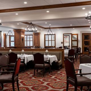 An elegant restaurant dining room with arranged tables and classic decor.
