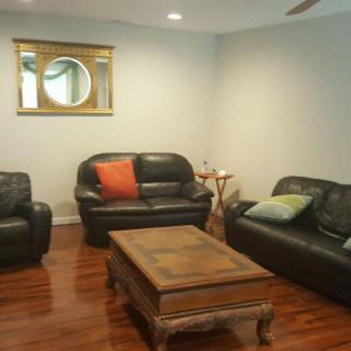 A cozy living room with leather sofas and a wooden coffee table.