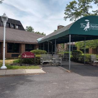 A welcoming entrance with a green canopy providing shelter for guests.