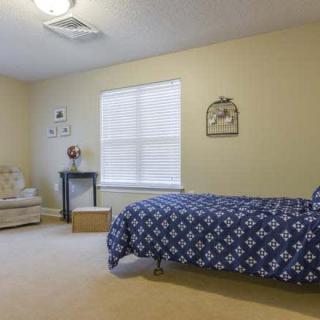 A cozy bedroom with a single bed and decorative elements.