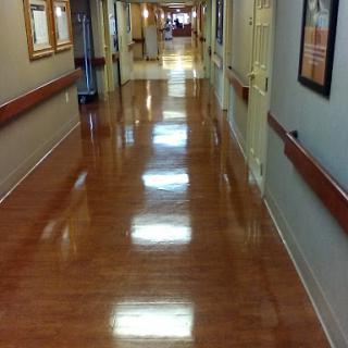 A well-lit hallway with polished floors and decorative walls.