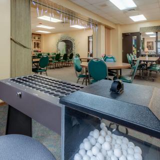 A spacious indoor game room equipped with bingo equipment and seating arrangements.