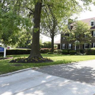 A charming residential home surrounded by lush greenery.