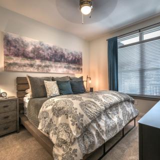 A modern bedroom with stylish furnishings and soft lighting.
