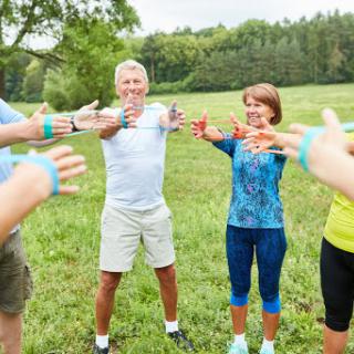 A group of people engaging in a fitness activity outdoors, promoting health and wellness.