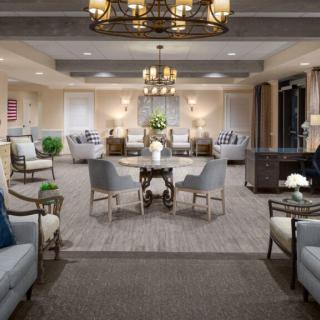 An elegantly designed living room with comfortable seating and chandeliers.